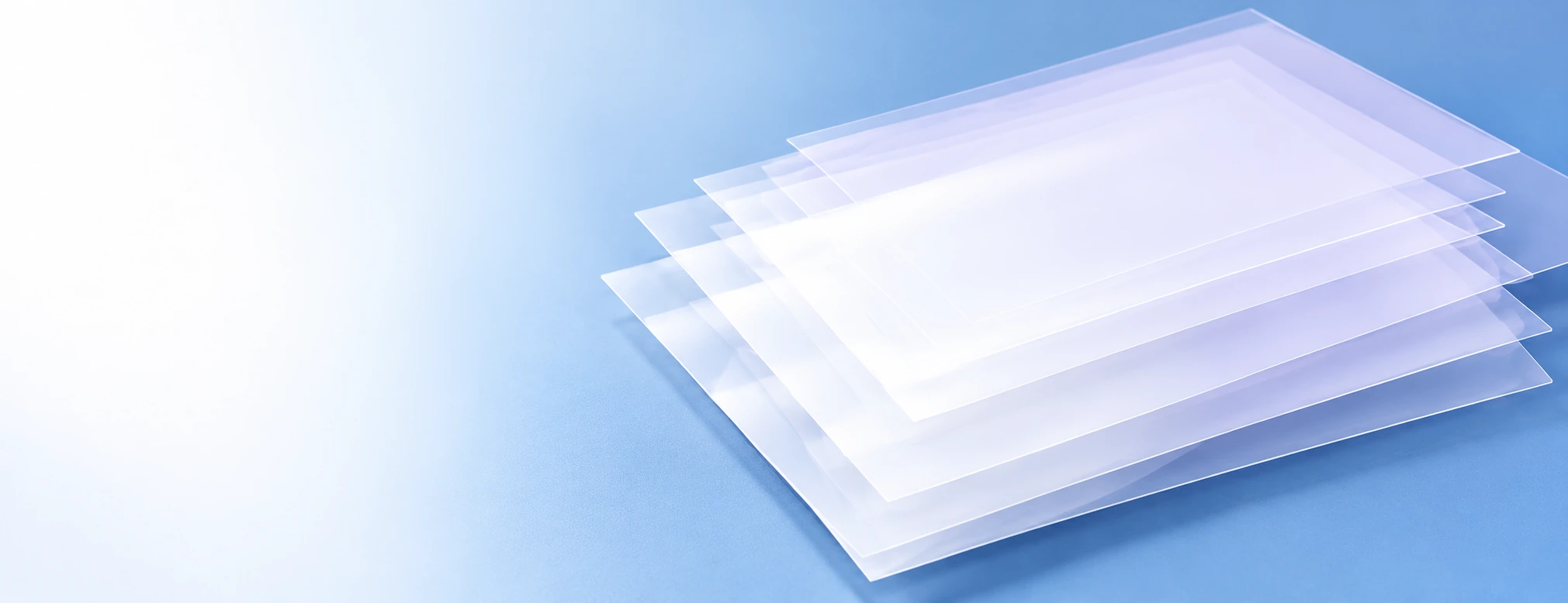 Transparent coated overlay sheets on a blue background